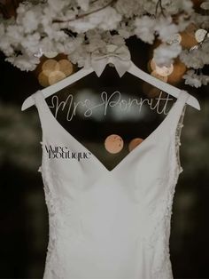 a wedding dress hanging on a hanger with the words mr and mrs pontatt