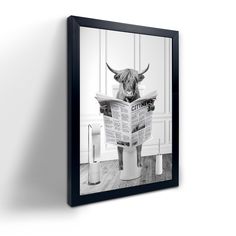 a black and white photo of a cow reading a newspaper on a toilet with the lid down