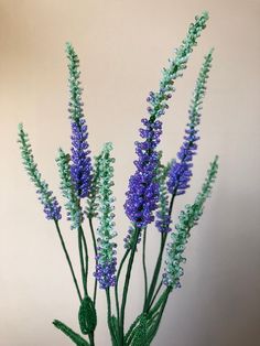 purple and green flowers are in a vase