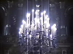 a large chandelier is lit up in the dark