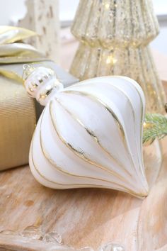 a white ornament sitting on top of a wooden table