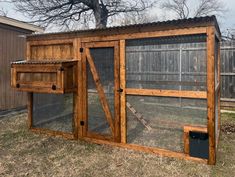 a chicken coop built into the side of a house