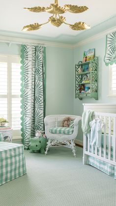 a baby's room with green and white decor