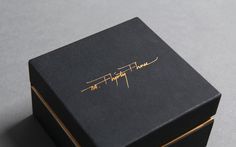 a black box with gold writing on it