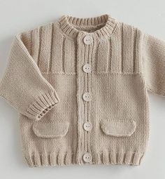 a knitted sweater with buttons on the chest and sleeves, in beige color is shown