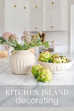 the kitchen island is decorated with flowers and succulents in white vases