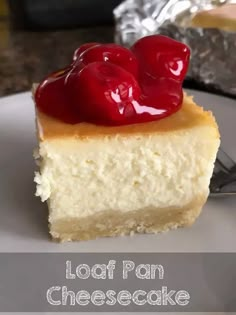 a piece of cheesecake with two cherries on top and the words, loaf pan cheesecake