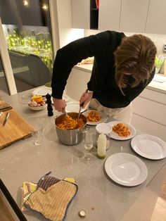 a woman is preparing food on the kitchen counter