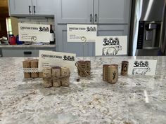 several pieces of wood sitting on top of a kitchen counter next to magnets and labels