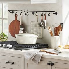 a kitchen with pots and pans hanging on the wall