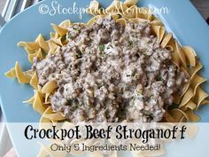 crockpot beef stroganoni f on a blue plate with text overlay