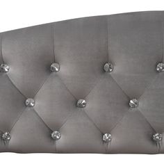 an upholstered headboard with silver buttons and studding on the back side