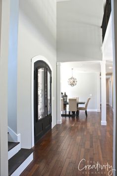 an image of a house with wood floors and white walls on the front door, which reads repose gray shewn williams