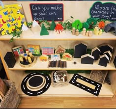 a display case filled with lots of different types of toys and books on top of wooden shelves