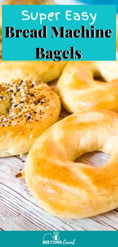 bagels with sesame seeds and poppy seed sprinkled on them are sitting on a wooden table