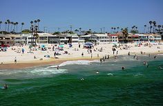 many people are on the beach and in the water at this point there is no image here to provide a caption for