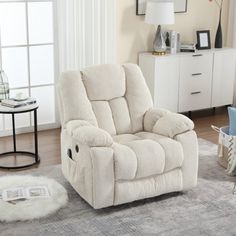 a living room with white furniture and rugs