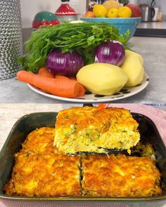 two plates with food on them and vegetables in the background