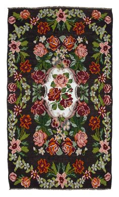 an old rug with flowers and leaves on it