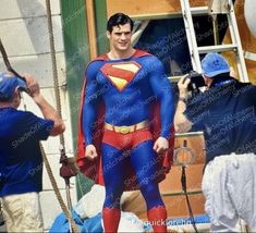 a man dressed as superman on the set of batman returns