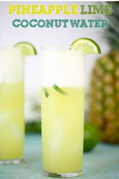 two glasses filled with pineapple lime coconut water on top of a blue tablecloth