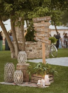 a wooden sign sitting on top of a lush green field