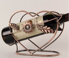 a wine bottle holder with a heart shaped design