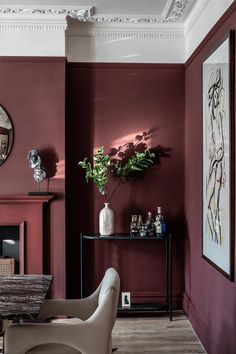 a living room filled with furniture and a fire place next to a wall mounted clock