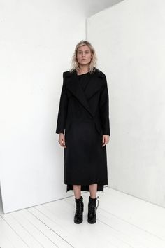 "Premium quality Black woolen coat has an oversize silhouette through the body , crafted in a heavy and thick high quality Italian wool fabric. Calf-length coat is fastened with two knobs. The coat has a unique cut , features big collar, long sleeves and is very stylish. This coat has a horizontal line through the front and back, there are large pockets in front. On one side on the shoulder is a decorative detail. The coat is with viscose lined. This coat is very stylish and unique created by a Modern Oversized Pea Coat For Winter, Modern Oversized Winter Pea Coat, Black Oversized Long Sleeve Pea Coat, Spring Black Wool Pea Coat, Modern Long Black Pea Coat, Modern Black Long Pea Coat, Modern Black Pea Coat With Lapel Collar, Modern Black Pea Coat For Winter, Black Wool Coat With Lapel Collar For Fall