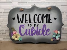 a sign that says welcome to my cuddle on the side of a brick wall