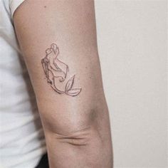 a woman's arm with a small tattoo on the left side of her arm