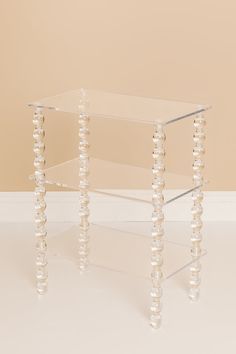 Elevate your space with this clear acrylic side table, featuring a sleek, modern design with sculptural legs with spherical accents that add a playful touch. Its three layers of shelving provide ample storage, making it both stylish and functional. Perfect for displaying decor, books, or essentials, this versatile piec Acrylic Home Decor, Bedside Table Ideas, Acrylic Side Table, Decor Books, Vintage Trends, Acrylic Decor, Decor Display, Window Shopping, Decorative Accents