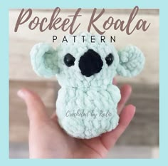 a crocheted koala is shown in the palm of someone's hand