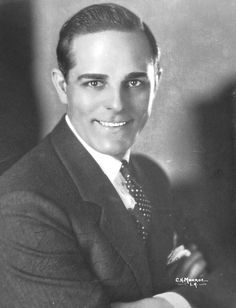 an old black and white photo of a man in a suit