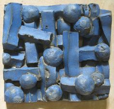 a sculpture made out of blue clay on a wall