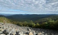 the mountains are covered in rocks and trees