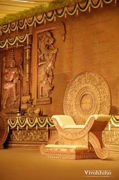 an ornately decorated room with gold and white decor on the walls, along with decorative wall hangings