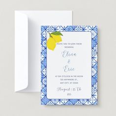 a blue and white wedding card with a lemon on the front, in an ornate frame