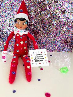 the elf is holding a sign in front of confetti sprinkles