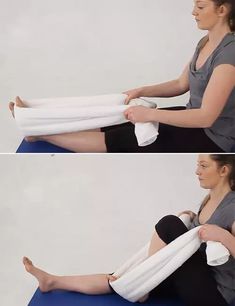 a woman is sitting on a blue mat with her leg wrapped in white towels and holding the towel