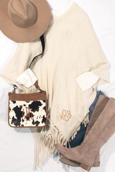 Stay cute and cozy this fall and winter in our Personalized Fringe Ponchos. Available in Ivory and Navy, these ponchos feature a fun fringe along the bottom of the hem. They are perfect for layering with our Monogrammed Long Sleeve Shir﻿t or Monogrammed Tunic Shirt. Add your favorite pair of leggings and some Monogrammed Boots to complete the look. Fringed Long Sleeve Poncho For Fall, Fringe Long Sleeve Poncho For Fall, Long Sleeve Fringe Poncho For Fall, Casual White Poncho For Fall, Beige Fringe Poncho For Fall, Cozy White Poncho For Fall, Casual Cream Poncho For Fall, Oversized White Poncho For Fall, White Fall Poncho