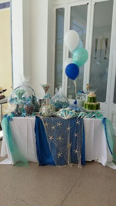 a table with balloons and decorations on it