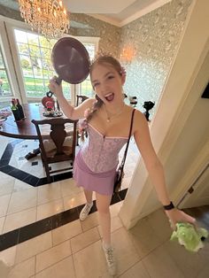 a woman in a pink corset is holding balloons and posing for the camera