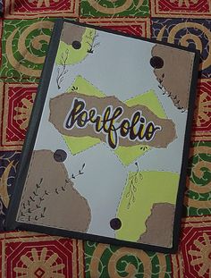 a card with the word berffolio on it sitting on top of a patterned table cloth