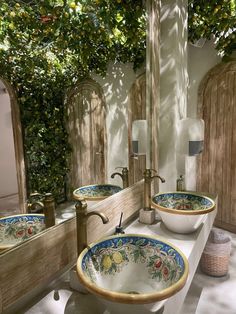 two sinks in a bathroom under a tree