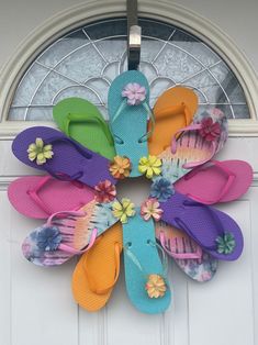 colorful flip flops are hanging on the front door