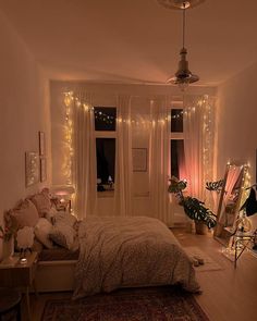 a bedroom with lights on the walls and a bed