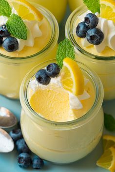 three glasses filled with lemon pudding and blueberries