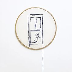 a drawing on a white wall with a wooden frame