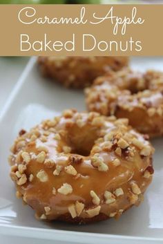 three glazed donuts on a white plate with the words baked donuts above them